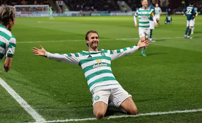 Celtic's Benjamin Nygren celebrates scoring their side's second goal during the Scottish Premiership soccer match between Motherwell and Celtic, Wednesday, May 13, 2026, in Motherwell, Scotland. (Robert Perry/PA via AP)