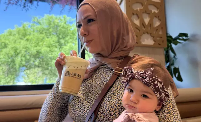 Hanan Jomaa drinks an iced pistachio latte inside Arwa Yemeni Coffee on April 6, 2026 in Sunnyvale, Calf. (AP Photo/Haven Daley)