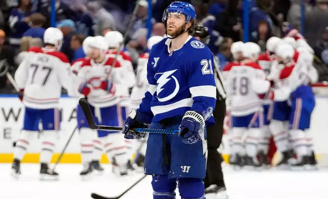 Tampa Bay Lightning center Brayden Point (21) skates off as the Montréal Canadiens celebrate their win in Game 7 of an NHL hockey Stanley Cup first-round playoff series, Sunday, May 3, 2026, in Tampa, Fla. (AP Photo/Chris O'Meara)