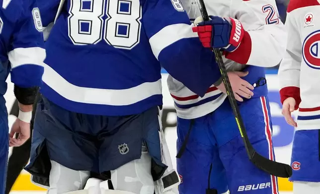 Tampa Bay Lightning goaltender Andrei Vasilevskiy (88) congraulates Montréal Canadiens center Phillip Danault (24) after the Canadiens defeated the Lightning in Game 7 of an NHL hockey Stanley Cup first-round playoff series, Sunday, May 3, 2026, in Tampa, Fla. (AP Photo/Chris O'Meara)