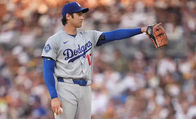 Los Angeles Dodgers starting pitcher Shohei Ohtani gestures as he works against a San Diego Padres batter during the fifth inning of a baseball game Wednesday, May 20, 2026, in San Diego. (AP Photo/Gregory Bull)
