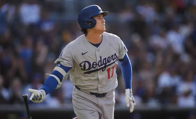 Los Angeles Dodgers' Shohei Ohtani watches his home run during the first inning of a baseball game against the San Diego Padres Wednesday, May 20, 2026, in San Diego. (AP Photo/Gregory Bull)