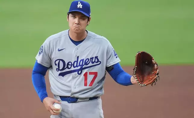 Los Angeles Dodgers starting pitcher Shohei Ohtani gestures as he works against a San Diego Padres batter during the fifth inning of a baseball game Wednesday, May 20, 2026, in San Diego. (AP Photo/Gregory Bull)