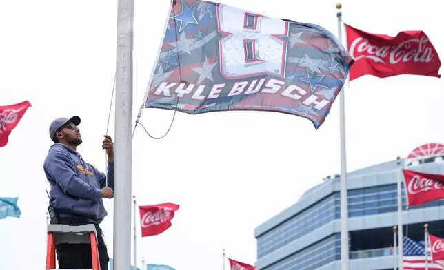 A flag is raised in honor of the late driver Kyle Busch outside of Charlotte Motor Speedway, Friday, May 22, 2026, in Charlotte, N.C. (AP Photo/Matt Kelley)