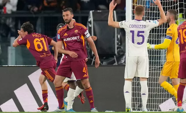 Roma's Niccolo Pisilli, left, celebrates after scoring his side's fourth goal during the Italian Serie A soccer match between Roma and Fiorentina in Rome, Monday, May 4, 2026. (AP Photo/Gregorio Borgia)