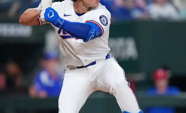 Texas Rangers' Justin Foscue loads up while waiting for a pitch from the Chicago Cubs during the sixth inning of a baseball game Saturday, May 9, 2026, in Arlington, Texas. (AP Photo/Julio Cortez)