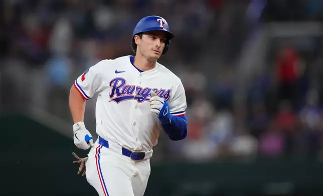 Texas Rangers' Justin Foscue runs the bases after hitting his first career home run during the third inning of a baseball game against the Chicago Cubs, Saturday, May 9, 2026, in Arlington, Texas. (AP Photo/Julio Cortez)