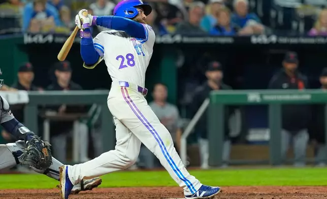 Kansas City Royals' Kyle Isbel watches his single to drive in the game-winning run during the ninth inning of a baseball game against the Detroit Tigers, Friday, May 8, 2026, in Kansas City, Mo. (AP Photo/Charlie Riedel)
