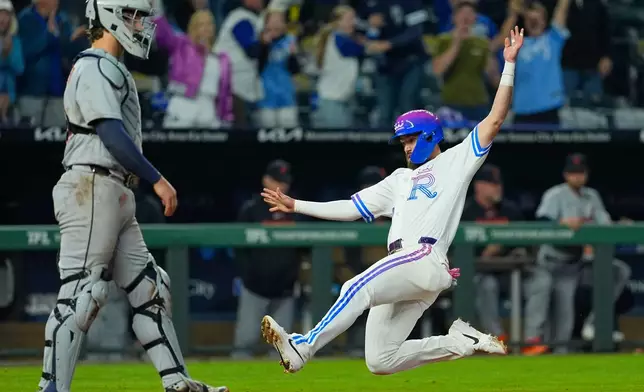 Kansas City Royals' Nick Loftin slides home to score the game-winning run on a single by Kyle Isbel during the ninth inning of a baseball game against the Detroit Tigers, Friday, May 8, 2026, in Kansas City, Mo. (AP Photo/Charlie Riedel)