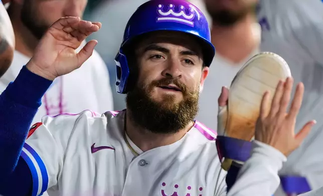 Kansas City Royals' Kyle Isbel celebrates in the dugout after scoring on a single by Maikel Garcia during the eighth inning of a baseball game against the Detroit Tigers, Friday, May 8, 2026, in Kansas City, Mo. (AP Photo/Charlie Riedel)