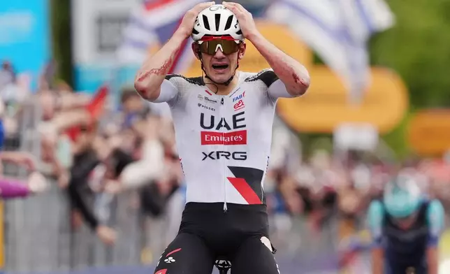 Spain's Igor Arrieta Lizarraga celebrates winning the fifth stage of the Giro d'Italia cycling race, from Praia a Mare to Potenza, Italy, Wednesday, May 13, 2026. (Massimo Paolone/LaPresse via AP)