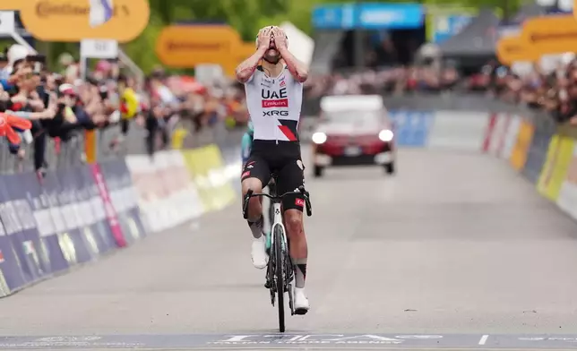 Spain's Igor Arrieta Lizarraga celebrates winning the fifth stage of the Giro d'Italia cycling race, from Praia a Mare to Potenza, Italy, Wednesday, May 13, 2026. (Marco Alpozzi/LaPresse via AP)