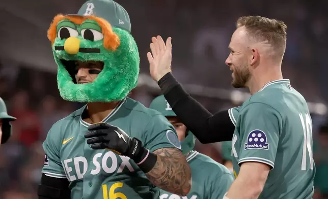 Boston Red Sox's Jarren Duran (16) and Trevor Story, right, celebrate after Duran's three-run home run during the third inning of a baseball game against the Houston Astros, Friday, May 1, 2026, in Boston. (AP Photo/Mark Stockwell)