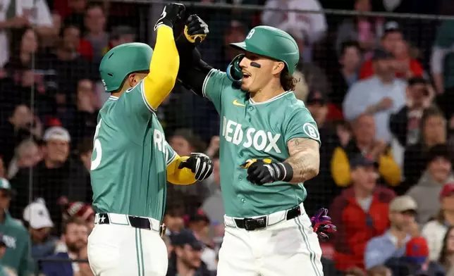 Boston Red Sox's Jarren Duran, right, and teammate Carlos Narváez, left, celebrate after Duran's three-run home run during the third inning of a baseball game against the Houston Astros, Friday, May 1, 2026, in Boston. (AP Photo/Mark Stockwell)