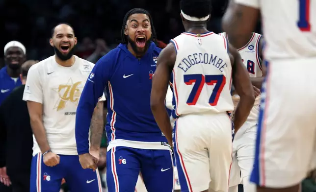 Philadelphia 76ers' players greet teammate VJ Edgecombe (77) after he hit a third quarter three point shot during Game 7 in a first-round NBA basketball playoffs series, Saturday, May 2, 2026 in Boston. (AP Photo/Jim Davis)