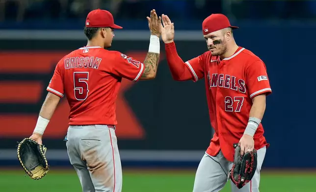 Los Angeles Angels' Mike Trout (27) celebrates with Vaughn Grissom (5) after the team defeated the Tampa Bay Rays during a baseball game Saturday, May 30, 2026, in St. Petersburg, Fla. (AP Photo/Chris O'Meara)