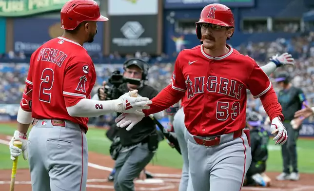 Los Angeles Angels' Wade Meckler (53) celebrates his grand slam off Tampa Bay Rays pitcher Drew Rasmussen with Oswald Peraza (2) during the first inning of a baseball game Saturday, May 30, 2026, in St. Petersburg, Fla. (AP Photo/Chris O'Meara)