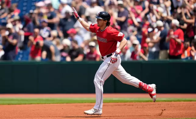 Cleveland Guardians' Chase DeLauter gestures as he runs the bases after hitting a home run in the first inning of a baseball game against the Cincinnati Reds in Cleveland, Sunday, May 17, 2026. (AP Photo/Sue Ogrocki)