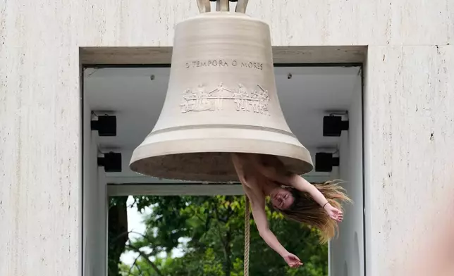 EDS NOTE: NUDITY - A performer rings a bell with her body at the Austrian pavilion called 'Seaworld Venice' by artist Ei Arakawa-Nash, at the Venice 2026 Biennale Art, in Venice, Italy, Thursday, Nov. 14, 2024. (AP Photo/Luca Bruno)