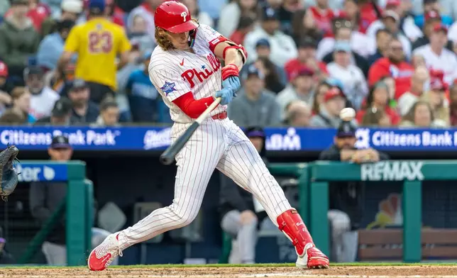 Philadelphia Phillies' Alec Bohm hits a solo home run during the third inning of a baseball game against the Colorado Rockies, Saturday, May 9, 2026, in Philadelphia. (AP Photo/Laurence Kesterson)