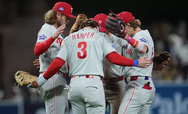Philadelphia Phillies first baseman Bryce Harper (3) celebrates with teammates after the Phillies defeated the San Diego Padres 4-3 in a baseball game Tuesday, May 26, 2026, in San Diego. (AP Photo/Gregory Bull)