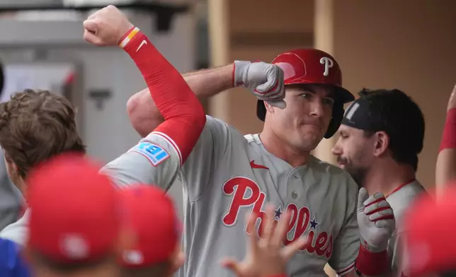 Philadelphia Phillies' J.T. Realmuto, right, celebrates with teammates after hitting a home run during the second inning of a baseball game against the San Diego Padres Tuesday, May 26, 2026, in San Diego. (AP Photo/Gregory Bull)
