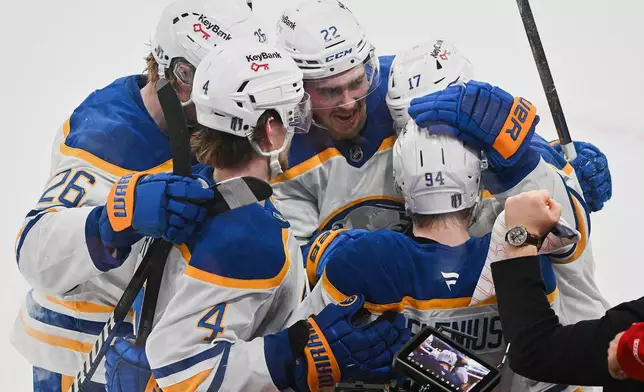 Buffalo Sabres' Konsta Helenius (94) celebrates with teammates after scoring against the Montreal Canadiens during the second period of Game 6 in a second-round NHL hockey Stanley Cup playoff series in Montreal, Saturday, May 16, 2026. (Graham Hughes/The Canadian Press via AP)