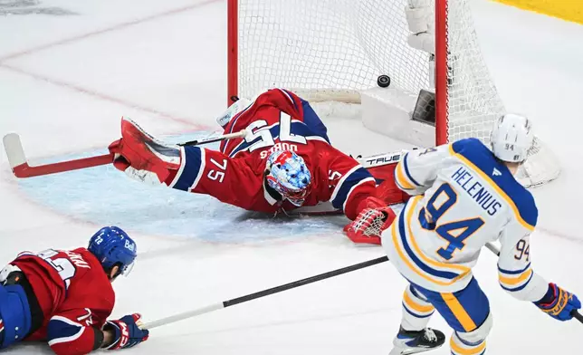 Buffalo Sabres' Konsta Helenius (94) scores against Montreal Canadiens goaltender Jakub Dobes (75) as Canadiens' Arber Xhekaj (72) defends during the second period of Game 6 in a second-round NHL hockey Stanley Cup playoff series in Montreal, Saturday, May 16, 2026. (Graham Hughes/The Canadian Press via AP)
