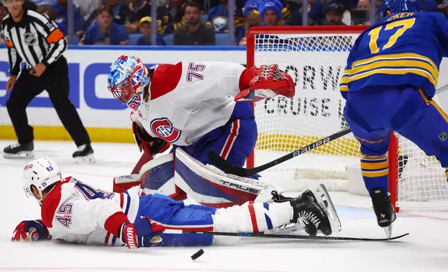 Montreal Canadiens defenseman Alexandre Carrier (45) blocks a shot by Buffalo Sabres left wing Jason Zucker (17) in front of Canadiens goaltender Jakub Dobes (75) during the first period in Game 7 of a second-round NHL hockey Stanley Cup playoff series Monday, May 18, 2026, in Buffalo, N.Y. (AP Photo/Jeffrey T. Barnes)