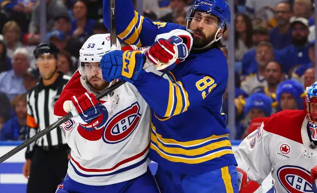 Montreal Canadiens defenseman Noah Dobson (53) and Buffalo Sabres right wing Alex Tuch (89) battle for position during the first period in Game 7 of a second-round NHL hockey Stanley Cup playoff series, Monday, May 18, 2026, in Buffalo, N.Y. (AP Photo/Jeffrey T. Barnes)