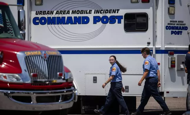 Emergency personnel work at the incident command post at the Los Alamitos Race Course Sunday, May 24, 2026, in Cypress, Calif. (AP Photo/Ethan Swope)