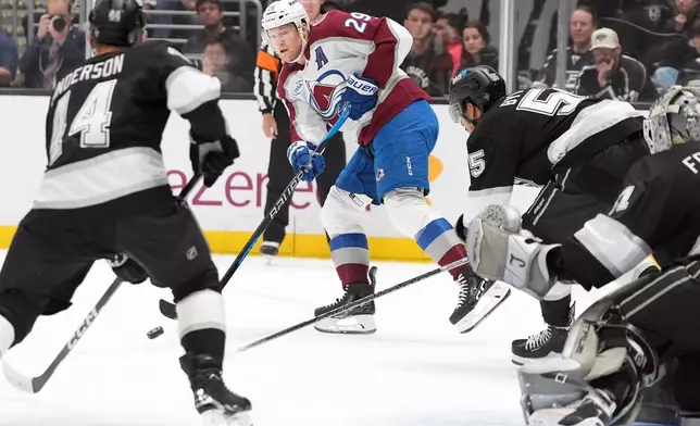 Colorado Avalanche's Nathan MacKinnon (29) passes the puck against the Los Angeles Kings during the first period of Game 4 in the first round of an NHL hockey Stanley Cup playoff series Sunday, April 26, 2026, in Los Angeles. (AP Photo/Scott Strazzante)