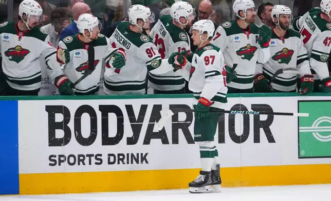 Minnesota Wild left wing Kirill Kaprizov (97) skates by his bench after scoring an open net goal against the Dallas Stars during the third period in Game 5 of a first-round NHL Stanley Cup playoffs hockey series, Tuesday, April 28, 2026, in Dallas. (AP Photo/Julio Cortez)