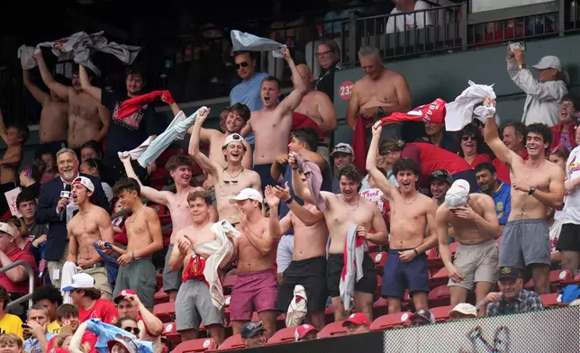 Fans cheer and wave their shirts above their heads during the fourth inning of a baseball game between the St. Louis Cardinals and the Kansas City Royals Saturday, May 16, 2026, in St. Louis. (AP Photo/Jeff Roberson)