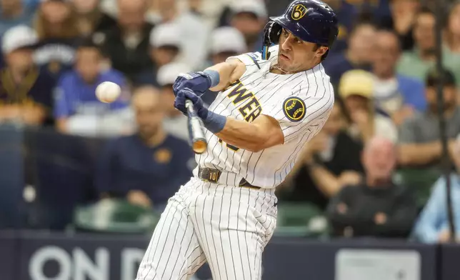 Milwaukee Brewers' Sal Frelick hits a run-scoring single during the first inning of a baseball game against the Los Angeles Dodgers, Saturday, May 23, 2026, in Milwaukee. (AP Photo/Jeffrey Phelps)