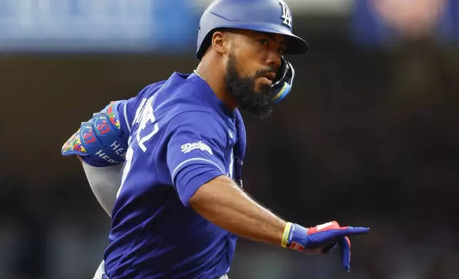 Los Angeles Dodgers' Teoscar Hernández reacts after hitting a three-run home run during the fourth inning of a baseball game against the Milwaukee Brewers, Saturday, May 23, 2026, in Milwaukee. (AP Photo/Jeffrey Phelps)
