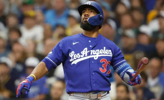 Los Angeles Dodgers' Teoscar Hernández watches his three-run home run during the fourth inning of a baseball game against the Milwaukee Brewers, Saturday, May 23, 2026, in Milwaukee. (AP Photo/Jeffrey Phelps)