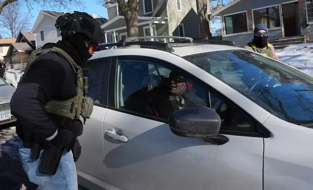 FILE - A federal agent approaches a vehicle on Jan. 29, 2026, in Minneapolis. (AP Photo/Adam Gray, File)