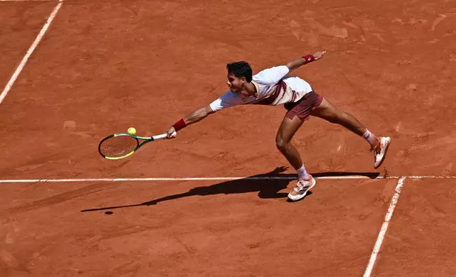 Adolfo Daniel Vallejo of Paraguay returns to Moise Kouame of France during their second round men's singles tennis match at the French Open tennis tournament in Paris, Thursday, May 28, 2026. (AP Photo/Emma Da Silva)