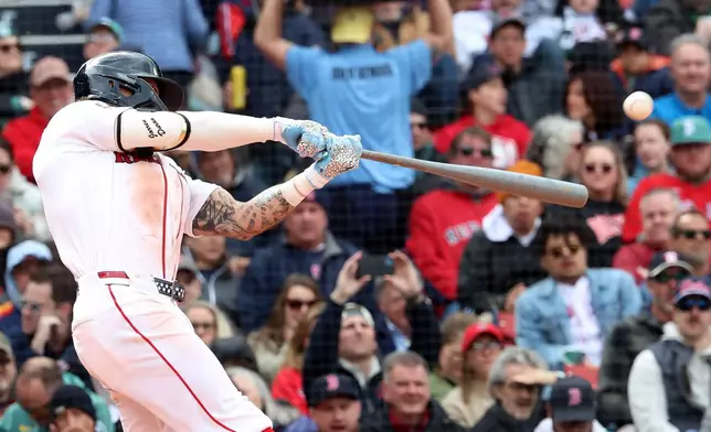 Boston Red Sox's Jarren Duran hits a solo home run during the fifth inning of a baseball game against the Houston Astros, Sunday, May 3, 2026, in Boston. (AP Photo/Mark Stockwell)