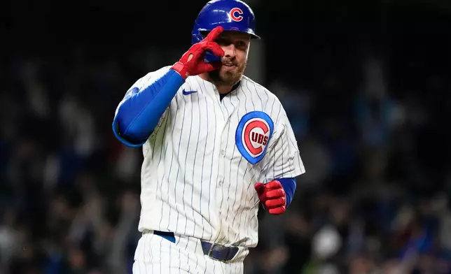 Chicago Cubs' Michael Busch celebrates as he rounds the bases after hitting a solo home run during the eighth inning of a baseball game against the Cincinnati Reds in Chicago, Tuesday, May 5, 2026. (AP Photo/Nam Y. Huh)