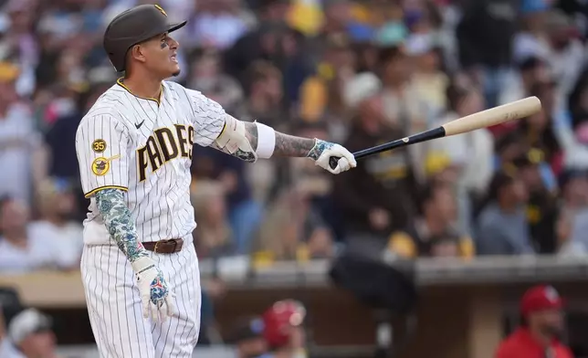 San Diego Padres' Manny Machado watches his home run during the eighth inning of a baseball game against the St. Louis Cardinals Saturday, May 9, 2026, in San Diego. (AP Photo/Gregory Bull)
