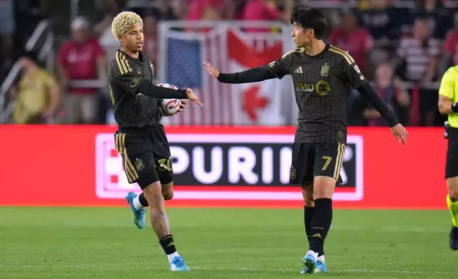 Los Angeles FC's David Martínez (30) is congratulated by teammate Son Heung-Min (7) after scoring during the second half of an MLS soccer match against St. Louis City Wednesday, May 13, 2026, in St. Louis. (AP Photo/Jeff Roberson)