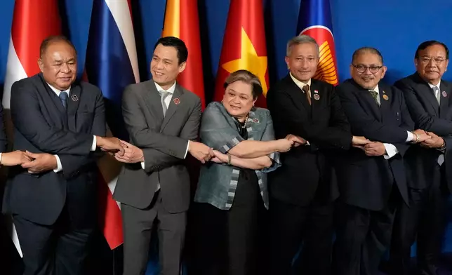 From left, East Timor's Foreign Minister Bendito dos Santos Freitas, Vietnam's Deputy Minister of Foreign Affairs Dang Hoang Giang, Philippine's Foreign Secretary Theresa Lazaro, Singapore's Foreign Minister Vivian Balakrishnan, Brunei's Second Foreign Minister Erywan Pehin Yusof, and Cambodia's Foreign Minister Prak Sokhonn hold hands during a group photo session at the ASEAN Foreign Ministers' Meeting at the Mactan Expo in Cebu province, central Philippines on Thursday, May 7, 2026. (AP Photo/Aaron Favila, Pool)