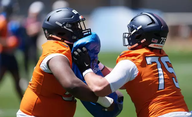 Denver Broncos center Zarian McGill, left, blocks center Jack Walsh during drills at the NFL football team's rookie minicamp, Saturday, May 9, 2026, at the team's headquarters in Centennial, Colo. (AP Photo/David Zalubowski)