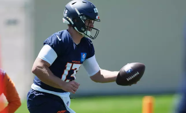 Denver Broncos quarterback E.J. Warner takes part in drills at the NFL football team's rookie minicamp Saturday, May 9, 2026, at the team's headquarters in Centennial, Colo. (AP Photo/David Zalubowski)