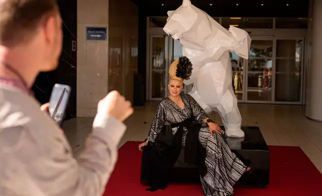 Elena Lenina poses for a photographer after walking on the red carpet for the movie "Parallel Talles" during the 79th international film festival, Cannes, southern France, Thursday, May 14, 2026. (AP Photo/Andreea Alexandru)