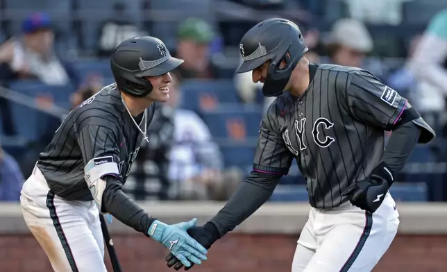 New York Mets' Hayden Senger, right, is congratulated by Carson Benge after hitting his first major league home run during the seventh inning of a baseball game against the Miami Marlins, Saturday, May 30, 2026, in New York. (AP Photo/Adam Hunger)