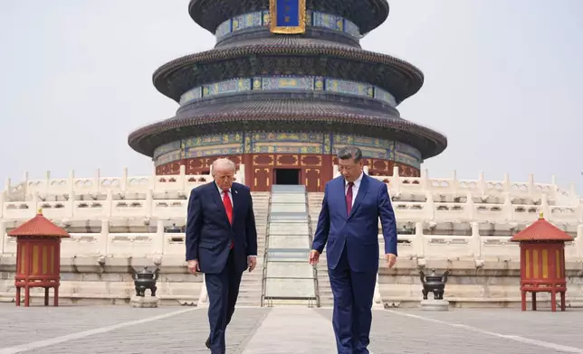 President Donald Trump, left, walks with Chinese President Xi Jinping at the Temple of Heaven on Thursday May 14, 2026, in Beijing. (AP Photo/Mark Schiefelbein)