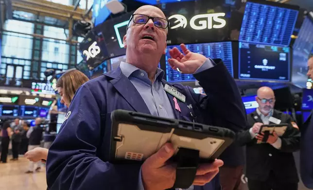 Trader Patrick Casey works on the floor of the New York Stock Exchange, Wednesday, May 13, 2026. (AP Photo/Richard Drew)